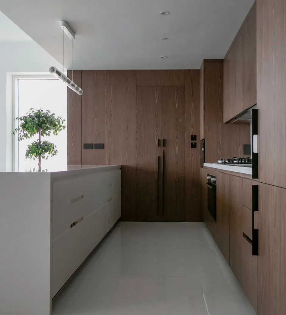 Kitchen with wood cabinetry and a white island, JBR